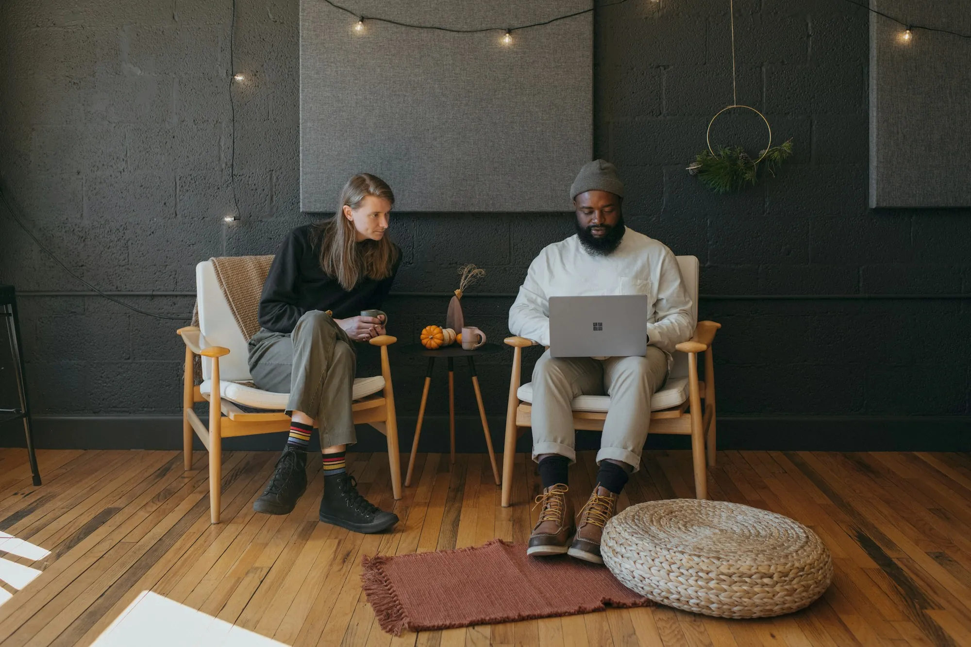 Two people talking in armchairs in a living room