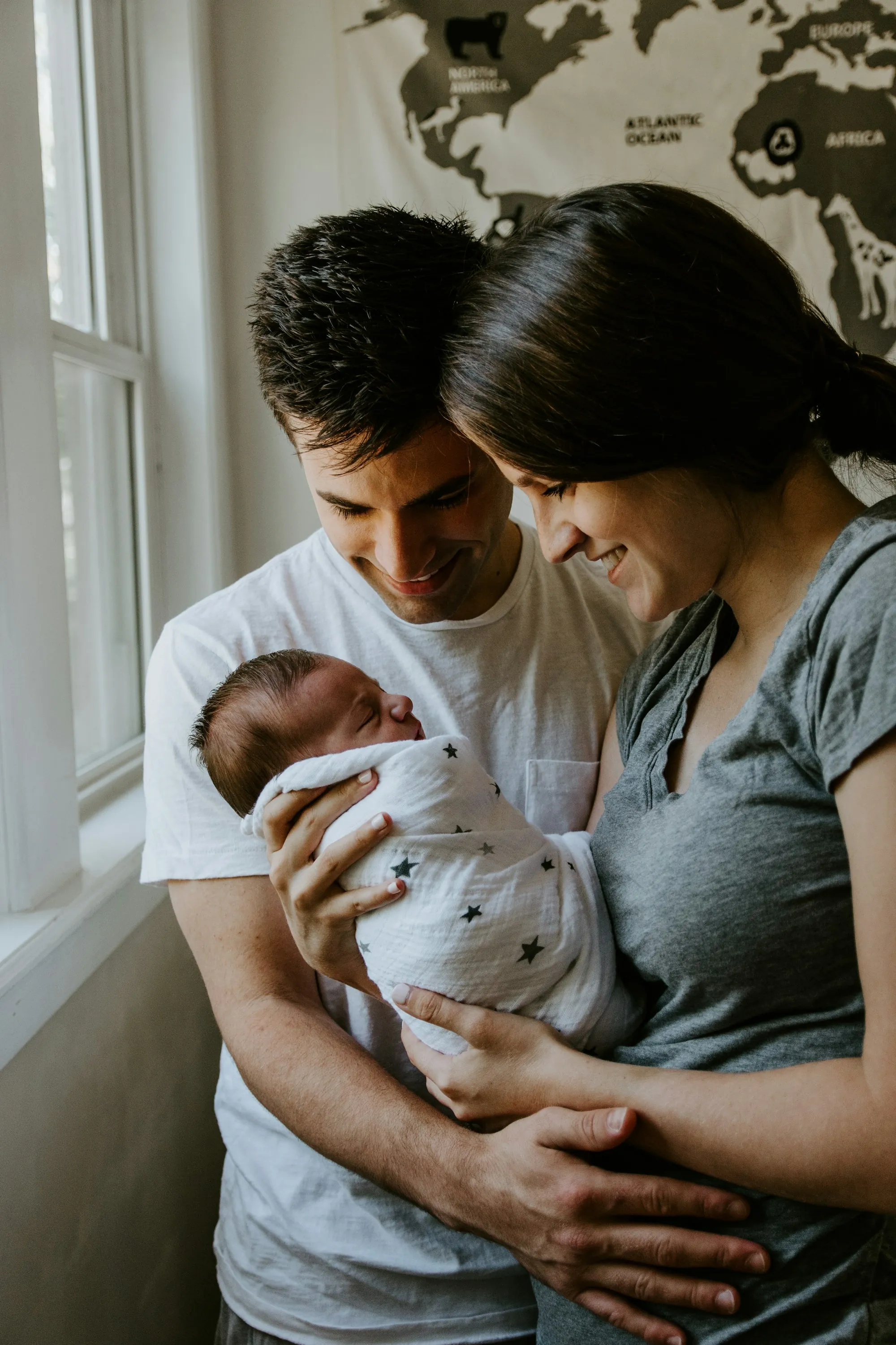 Parents gazing at their sleeping newborn