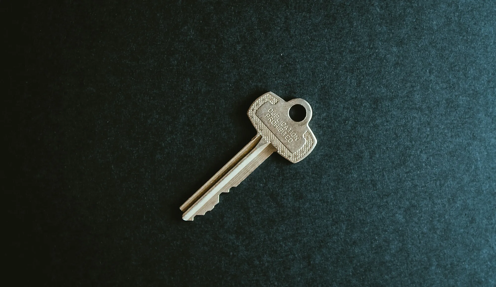 Single key on a dark surface