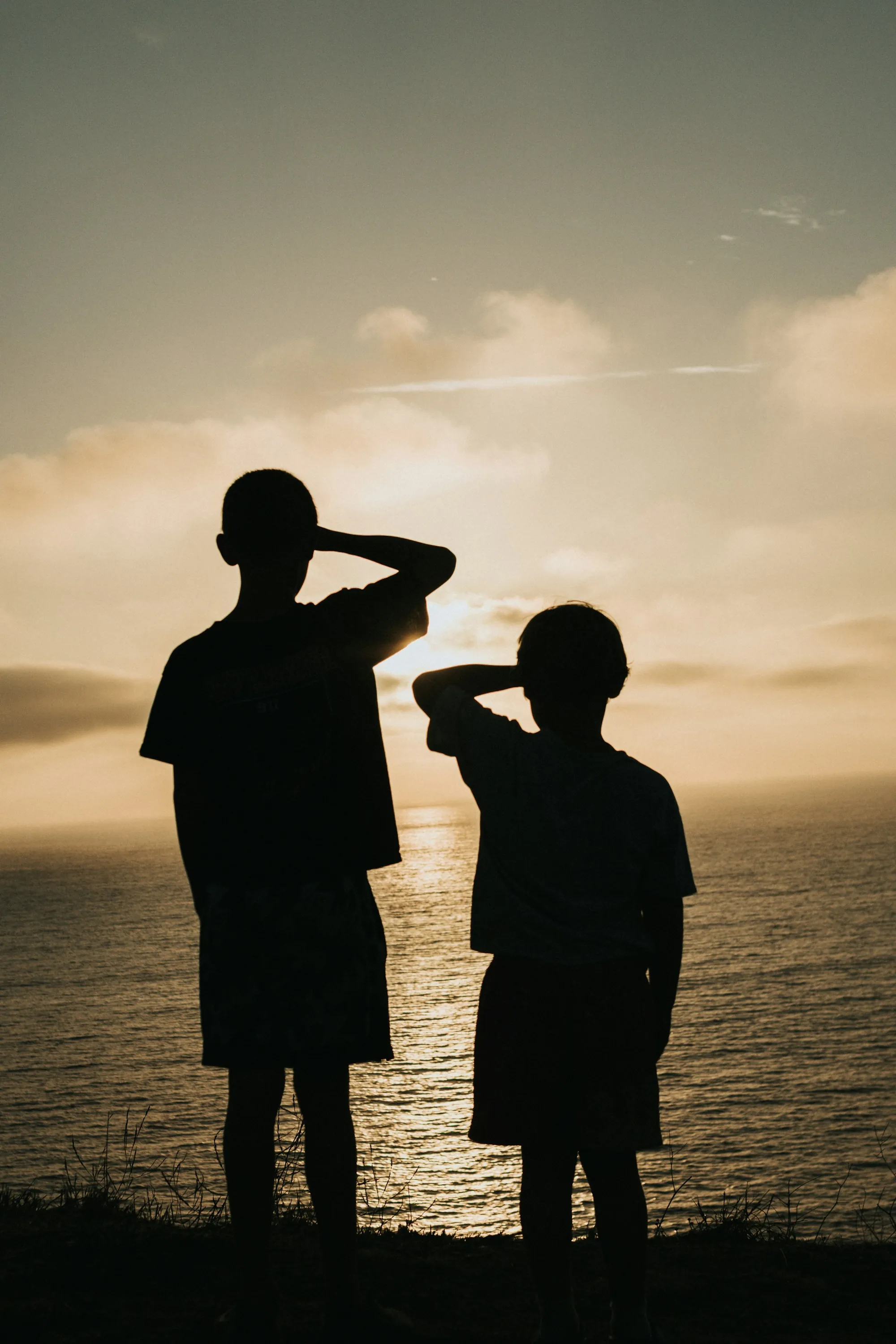 Silhouettes of a father and son at sunset